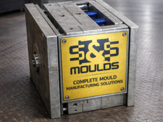 Industrial steel mould with yellow nameplate